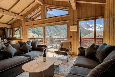 a living room with couches and a large window at Apartment Soleil, Alpes Travel, Argentière, Sleeps 9 in Chamonix-Mont-Blanc