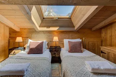 two beds in a room with a skylight at Apartment Soleil, Alpes Travel, Argentière, Sleeps 9 in Chamonix-Mont-Blanc