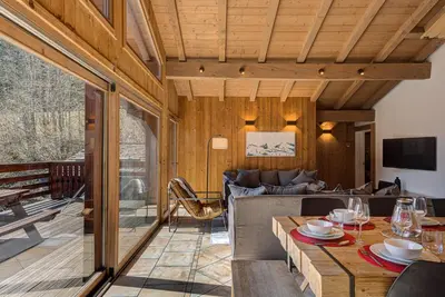 a living room with a table and a couch at Apartment Soleil, Alpes Travel, Argentière, Sleeps 9 in Chamonix-Mont-Blanc