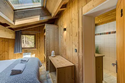 a bedroom with a bed and a bathroom with a shower at Apartment Soleil, Alpes Travel, Argentière, Sleeps 9 in Chamonix-Mont-Blanc