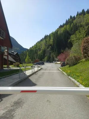 an empty road with a mountain in the background at Au pied des pistes in Les Contamines-Montjoie