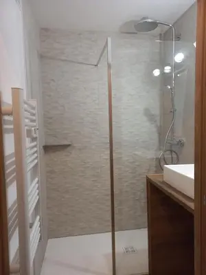 a glass shower in a bathroom with a sink at Au pied des pistes in Les Contamines-Montjoie