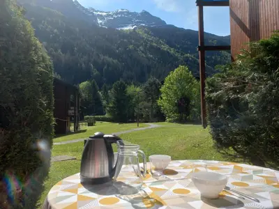 a table with a tea kettle and cups on it at Au pied des pistes in Les Contamines-Montjoie