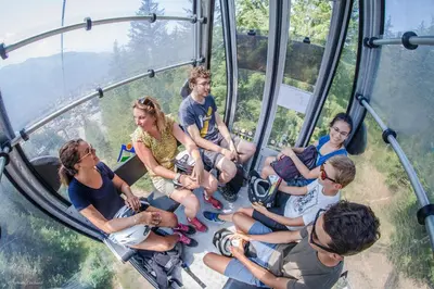 a group of people sitting in a gondola ride at ROUS02 Appartement 6 8 personnes au centre station in Les Carroz d'Araches