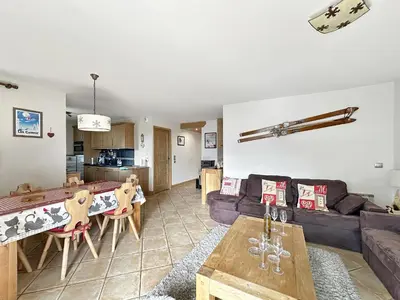a living room with a couch and a table at ROUS02 Appartement 6 8 personnes au centre station in Les Carroz d'Araches