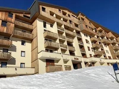 a large building with snow in front of it at Samoëns 1600 au pied des pistes in Samoëns