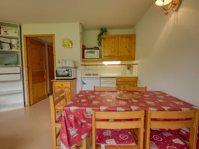 a kitchen with a table and chairs and a kitchen with a table and a table at Appartement 1 chambre, coin montagne, vue pistes, 4-6 pers, sud, skis - FR-1-642-102 in Morillon