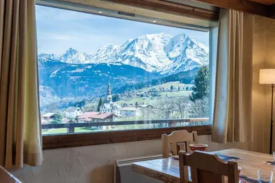 a large window with a view of a mountain at Chalet Sapi in Combloux