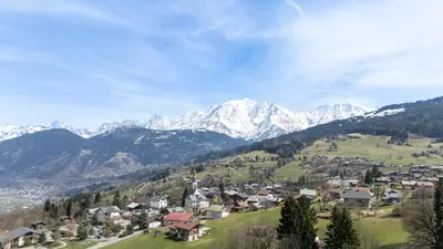 a small town in a valley with snow capped mountains at Chalet Sapi in Combloux