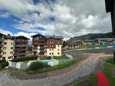 a group of apartment buildings in a city with a pool at Studio rénové pour 4 pers, animaux admis - FR-1-642-103 in Morillon