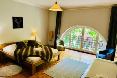 a bedroom with a bed and an arched window at Magnificent duplex in a former Palace in Chamonix-Mont-Blanc