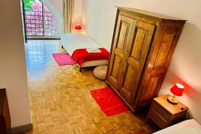 a room with two beds and a wooden cabinet at Magnificent duplex in a former Palace in Chamonix-Mont-Blanc