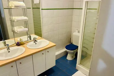 a bathroom with two sinks and a blue toilet at Magnificent duplex in a former Palace in Chamonix-Mont-Blanc