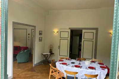 a dining room table with a white table cloth on it at Magnificent duplex in a former Palace in Chamonix-Mont-Blanc