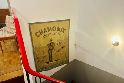 a poster of a man on skis on a wall at Magnificent duplex in a former Palace in Chamonix-Mont-Blanc