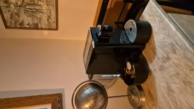 a hair dryer hanging on a wall next to a mirror at Le studio du Cerf in Chamonix-Mont-Blanc