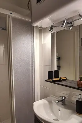 a bathroom with a sink and a mirror at Le studio du Cerf in Chamonix-Mont-Blanc