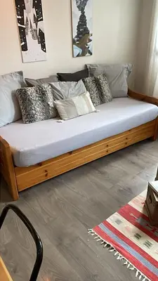 a bed with pillows on it in a room at Le studio du Cerf in Chamonix-Mont-Blanc