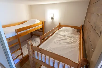 two bunk beds in a small room at Cabana & Alp'évasion - Pools, Sauna, Pool Table in Samoëns