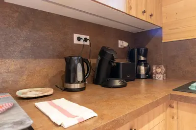 a kitchen counter with two coffee makers on it at Cabana & Alp'évasion - Pools, Sauna, Pool Table in Samoëns