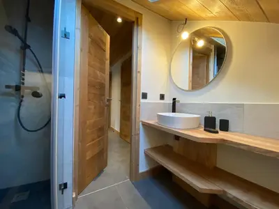 a bathroom with a sink and a mirror at Les Séracs in Combloux