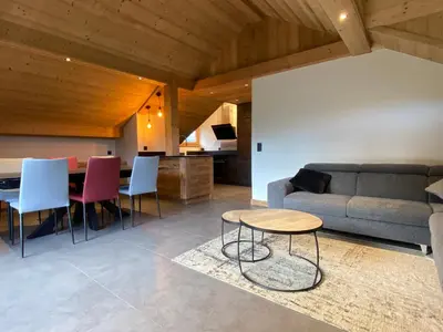 a living room with a couch and a table at Les Séracs in Combloux