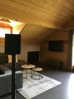 a living room with a couch and a flat screen tv at Les Séracs in Combloux