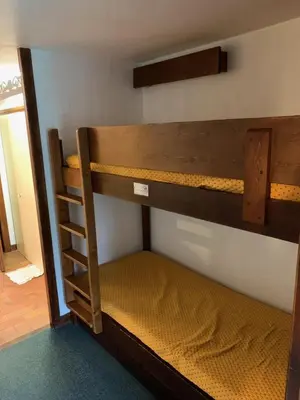 a bedroom with two bunk beds in a room at Mont arbois megeve in Megève
