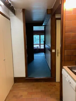a hallway with a door leading into a kitchen at Mont arbois megeve in Megève
