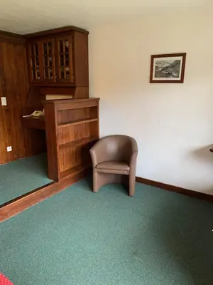 a room with a chair in the corner of a room at Mont arbois megeve in Megève