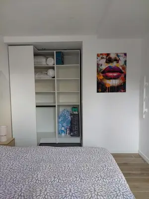 a bedroom with a bed and a painting on the wall at Appartement adapté PMR 4 personnes Saint Gervais les Bains in Saint-Gervais-les-Bains