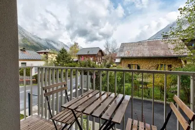a wooden deck with a wooden bench on a balcony at White Pearl Mountains Modern 2-bedroom apartment with great location in Chamonix-Mont-Blanc