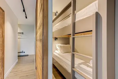 a small room with bunk beds in it at White Pearl Mountains Modern 2-bedroom apartment with great location in Chamonix-Mont-Blanc