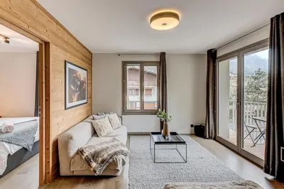 a living room with a couch and a table at White Pearl Mountains Modern 2-bedroom apartment with great location in Chamonix-Mont-Blanc