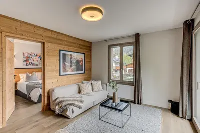 a living room with a couch and a bed at White Pearl Mountains Modern 2-bedroom apartment with great location in Chamonix-Mont-Blanc