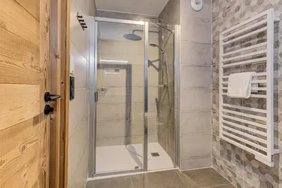 a shower with a glass door in a bathroom at White Pearl Mountains Modern 2-bedroom apartment with great location in Chamonix-Mont-Blanc
