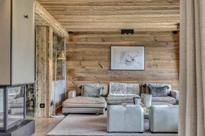 a living room with a couch and a table at Chalet de luxe proche du village de Megève in Megève
