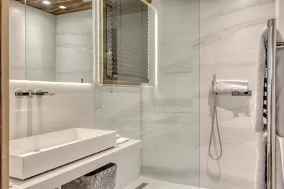 a white bathroom with a sink and a shower at Chalet de luxe proche du village de Megève in Megève