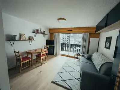 a living room with a couch and a table at Le Montenvers - Central Studio & Private parking in Chamonix-Mont-Blanc