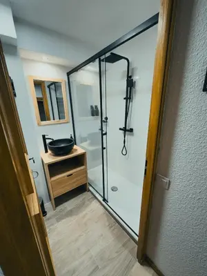 a bathroom with a shower with a glass door at Le Montenvers - Central Studio & Private parking in Chamonix-Mont-Blanc
