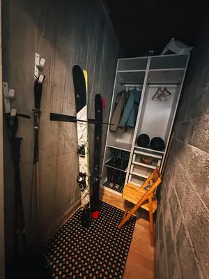 a bunch of skis are hanging on a wall at Le Montenvers - Central Studio & Private parking in Chamonix-Mont-Blanc