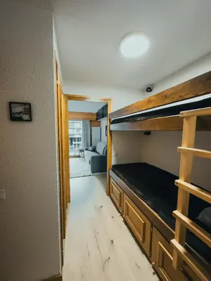 a bedroom with a bunk bed in a room at Le Montenvers - Central Studio & Private parking in Chamonix-Mont-Blanc