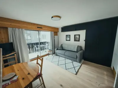 a living room with a couch and a table at Le Montenvers - Central Studio & Private parking in Chamonix-Mont-Blanc