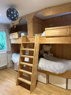 a wooden bunk bed with a teddy bear in a room at Rouge-Gorge, Appartement de charme, 3 chambres, Megève - Rochebrune in Megève