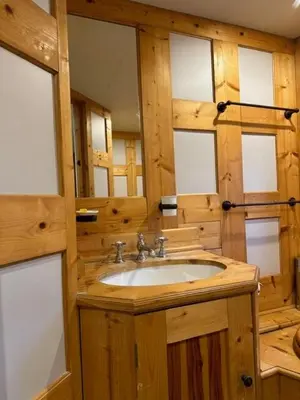a wooden bathroom with a sink and a mirror at Rouge-Gorge, Appartement de charme, 3 chambres, Megève - Rochebrune in Megève