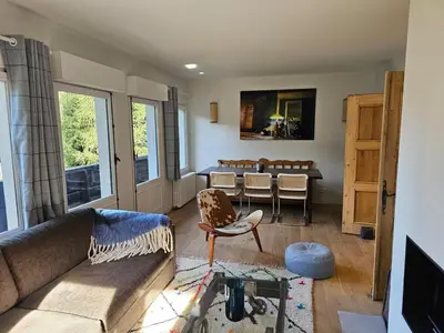 a living room with a couch and a table at Rouge-Gorge, Appartement de charme, 3 chambres, Megève - Rochebrune in Megève