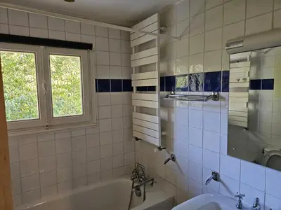 a bathroom with a tub and a sink and a window at Rouge-Gorge, Appartement de charme, 3 chambres, Megève - Rochebrune in Megève