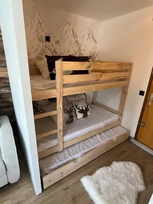 a bedroom with a bed with a mountain mural on the wall at Studio Carroz d'Arâches 4 pers in Arâches-la-Frasse