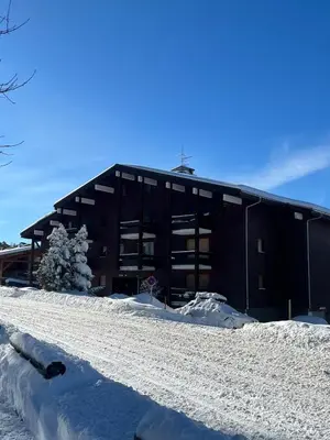 a black building with snow in front of it at Studio Carroz d'Arâches 4 pers in Arâches-la-Frasse
