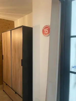 a clock on a wall next to a locker at Cozy & modern apartment in Samoëns